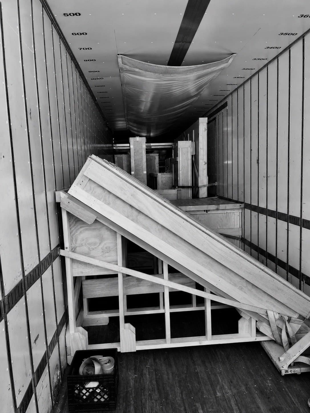 Custom wooden transport structure secured inside a trailer
